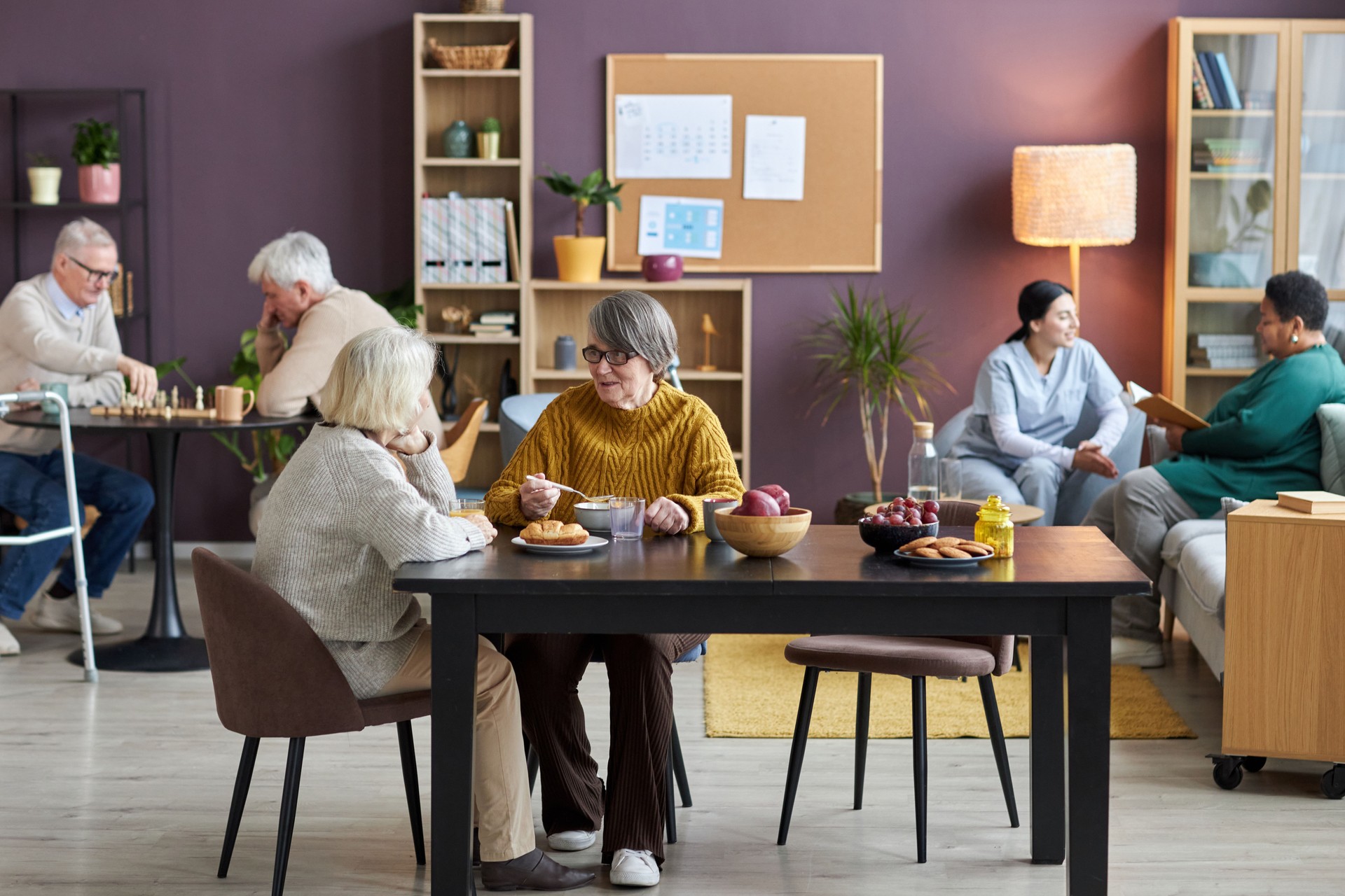 Common room in retirement home with seniors enjoying leisure activities