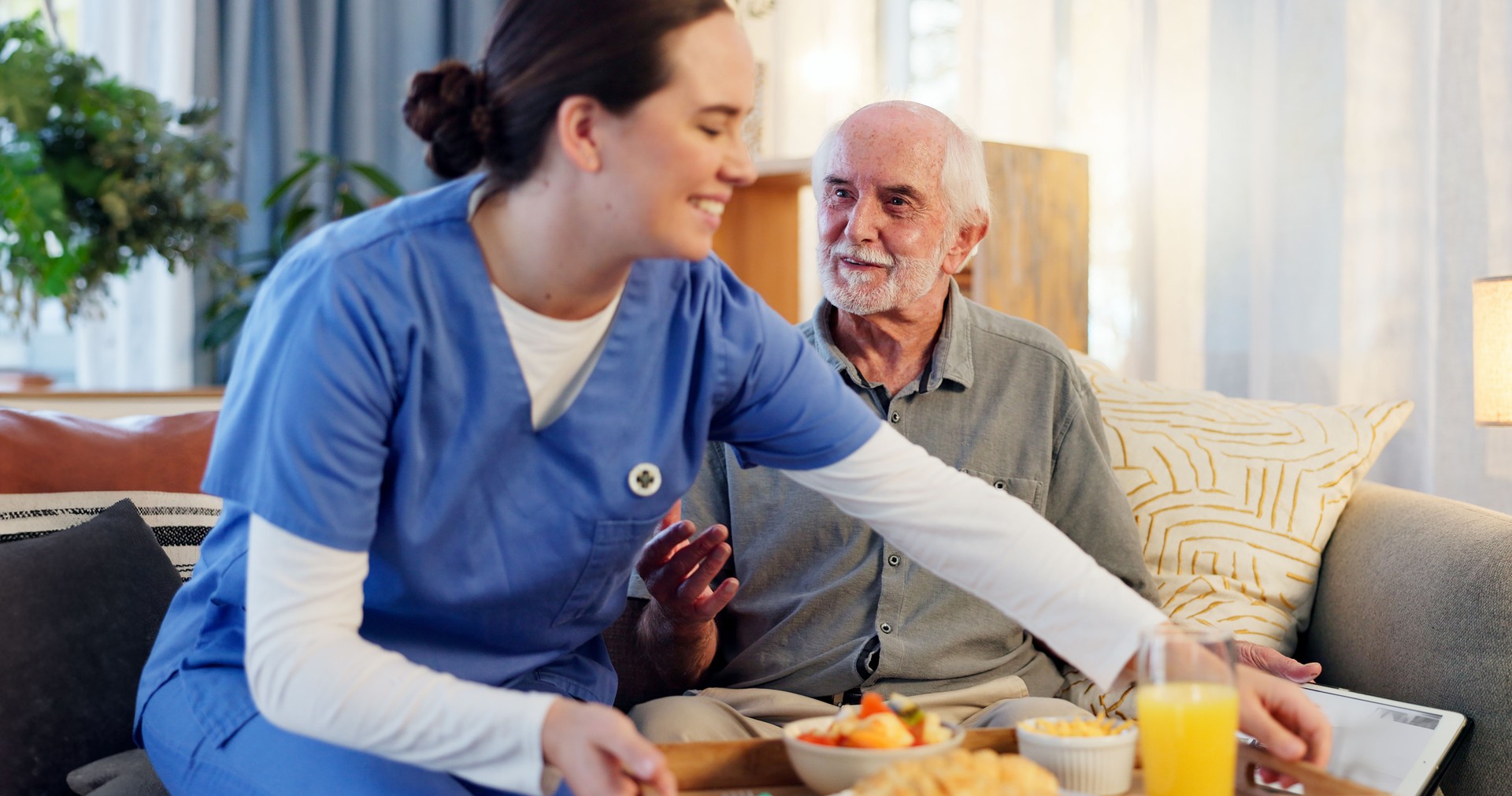 Breakfast, nurse and senior man in nursing home for elderly care, nutrition and support. Retired male person, caregiver and service for hungry patient in assisted living, healthcare and wellness